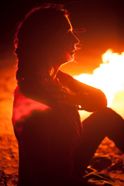 HeatherAsh Amara hand over heart in front of fire photo